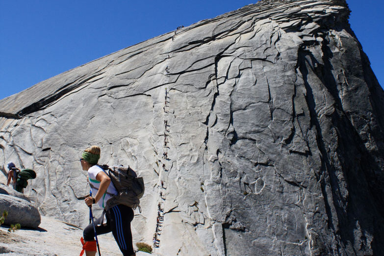 Stephanie Aikin hiking up a rock.