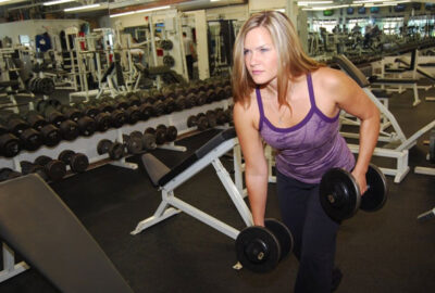 Stephanie Aikin lifting weights in her gym.