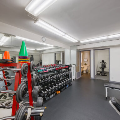 Move Your Mountain inside with rack of dumb-bells and other exercising equipment.