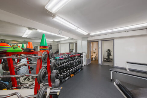 Move Your Mountain inside with rack of dumb-bells and other exercising equipment.