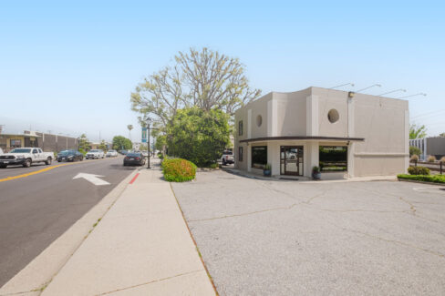 Move Your Mountain exterior shot with cars driving along the street.